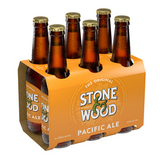 Six-pack of Stone & Wood Pacific Ale bottles in an orange carrier on a white background