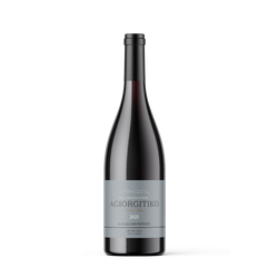 A single dark glass wine bottle with a gray label reading 'AGIORGITIKO' and 'KAMA WINEMAKERY', centered on a light gray background.