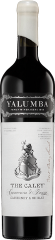 A bottle of Valumba Family Winery Red 2015 'The Calky' Cabernet Sauvignon Shiraz red wine, featuring a white label with a detailed crest and black text, topped with a white paper neck wrap.